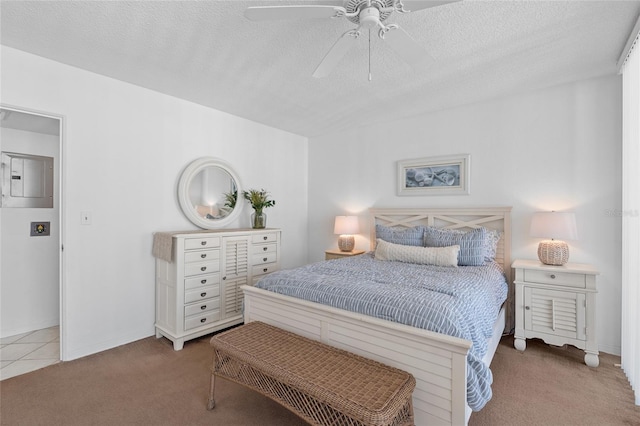 carpeted bedroom featuring baseboards, a ceiling fan, a textured ceiling, and electric panel