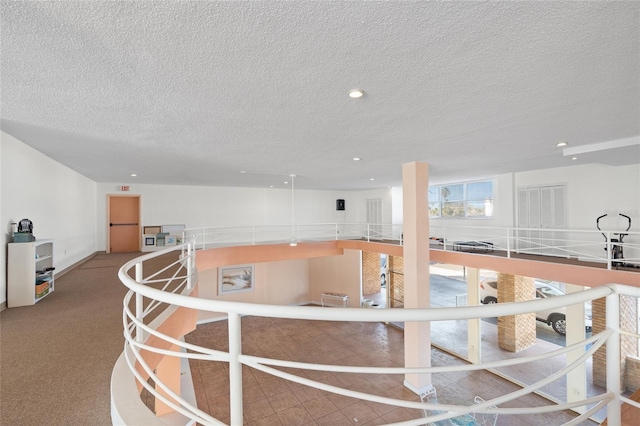 interior space with carpet flooring, a textured ceiling, and recessed lighting