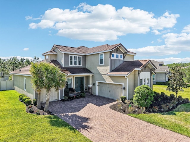 3952 Bonfire Dr, Odessa, FL 33556 - view of front of house with decorative driveway, a garage, stucco siding, a tile roof, and a front yard