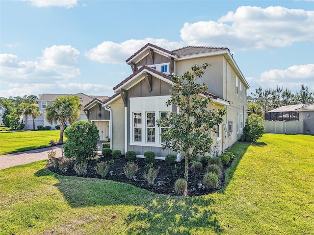 3952 Bonfire Dr, Odessa, FL 33556 - view of property exterior featuring a yard, stucco siding, a tiled roof, and board and batten siding