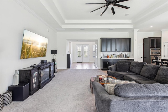 3952 Bonfire Dr, Odessa, FL 33556 - living area featuring a tray ceiling, crown molding, light carpet, and a ceiling fan