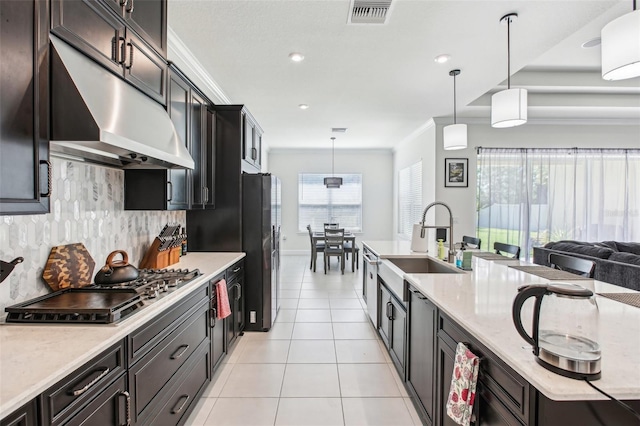 3952 Bonfire Dr, Odessa, FL 33556 - kitchen with a sink, stainless steel appliances, visible vents, under cabinet range hood, and decorative backsplash