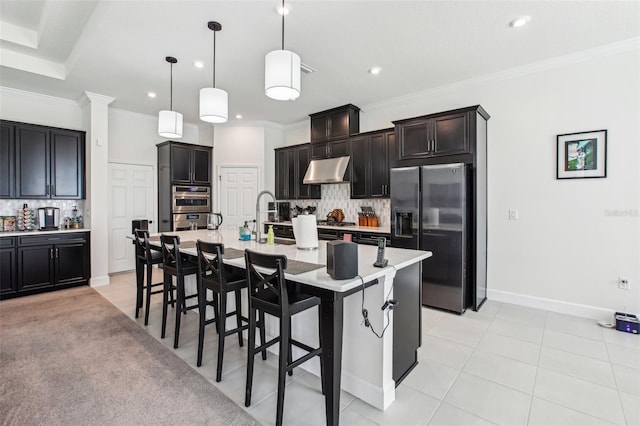 3952 Bonfire Dr, Odessa, FL 33556 - kitchen with stainless steel appliances, tasteful backsplash, under cabinet range hood, and a kitchen bar