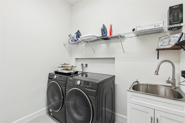 3952 Bonfire Dr, Odessa, FL 33556 - clothes washing area with cabinet space, washer and clothes dryer, baseboards, and a sink