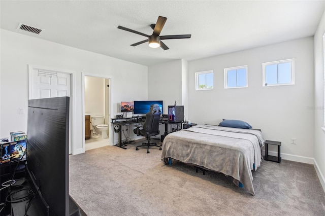 3952 Bonfire Dr, Odessa, FL 33556 - carpeted bedroom with ensuite bath, visible vents, baseboards, and a ceiling fan