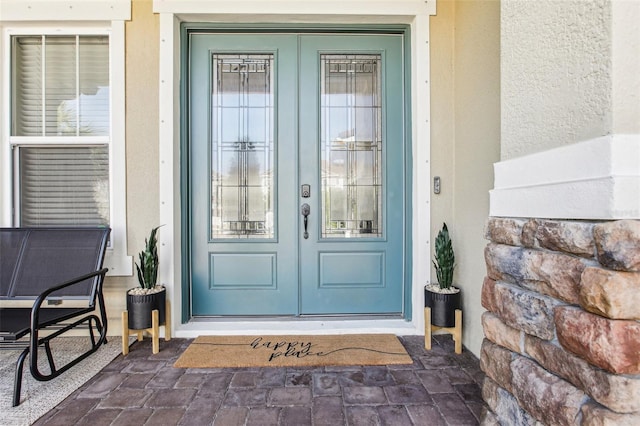 3952 Bonfire Dr, Odessa, FL 33556 - doorway to property featuring stucco siding and french doors