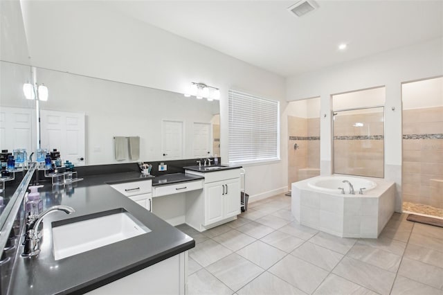 3952 Bonfire Dr, Odessa, FL 33556 - full bathroom featuring a sink, two vanities, a walk in shower, tile patterned floors, and a bath