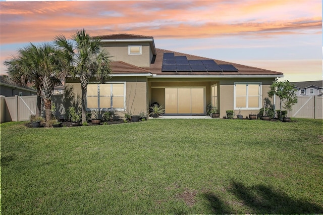 3952 Bonfire Dr, Odessa, FL 33556 - back of property with a yard, a gate, a fenced backyard, and roof mounted solar panels