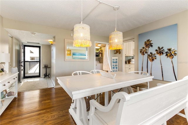 1581 Gulf Blvd Unit 301N, Clearwater Beach, FL 33767 - dining room featuring wood finished floors, a textured ceiling, baseboards, and a notable chandelier
