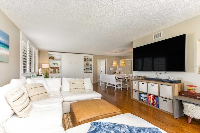 1581 Gulf Blvd Unit 301N, Clearwater Beach, FL 33767 - living area with visible vents, wood finished floors, and a textured ceiling