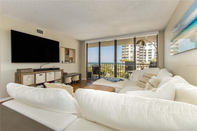 1581 Gulf Blvd Unit 301N, Clearwater Beach, FL 33767 - living room with wood finished floors, visible vents, and a textured ceiling
