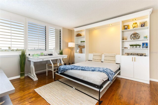 1581 Gulf Blvd Unit 301N, Clearwater Beach, FL 33767 - bedroom featuring baseboards, wood finished floors, and a textured ceiling