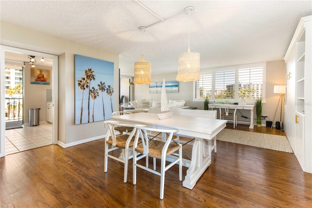 1581 Gulf Blvd Unit 301N, Clearwater Beach, FL 33767 - dining space with a chandelier, wood finished floors, and a textured ceiling