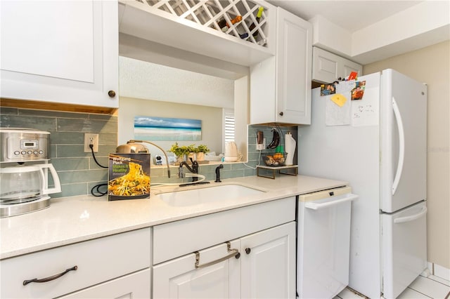 1581 Gulf Blvd Unit 301N, Clearwater Beach, FL 33767 - kitchen featuring white cabinets, tasteful backsplash, a sink, and white appliances