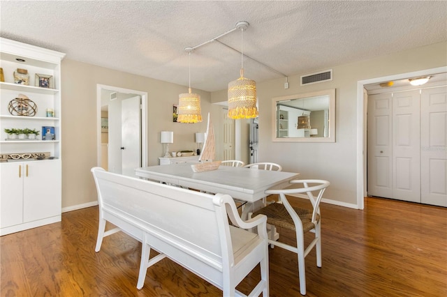 1581 Gulf Blvd Unit 301N, Clearwater Beach, FL 33767 - dining room featuring a textured ceiling, wood finished floors, and visible vents
