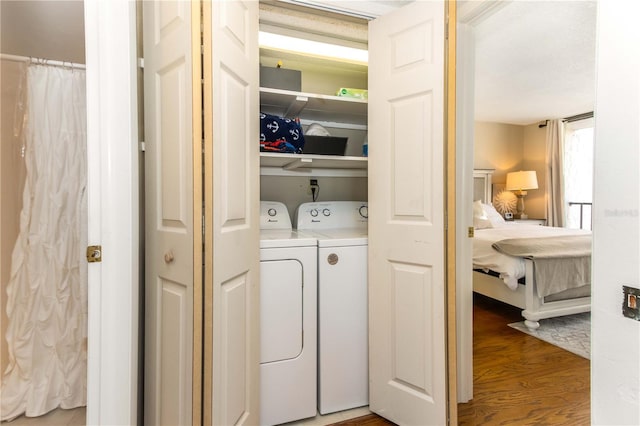 1581 Gulf Blvd Unit 301N, Clearwater Beach, FL 33767 - washroom featuring wood finished floors, separate washer and dryer, and laundry area