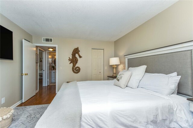 1581 Gulf Blvd Unit 301N, Clearwater Beach, FL 33767 - bedroom with a closet, wood finished floors, visible vents, and baseboards