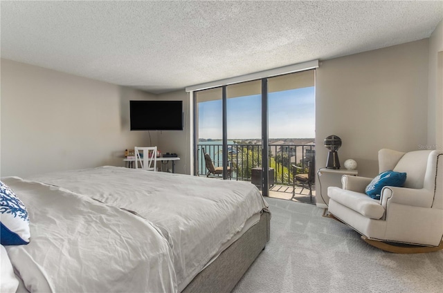 1581 Gulf Blvd Unit 301N, Clearwater Beach, FL 33767 - carpeted bedroom with expansive windows, a textured ceiling, and access to outside