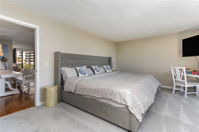 1581 Gulf Blvd Unit 301N, Clearwater Beach, FL 33767 - bedroom with a textured ceiling, carpet flooring, and baseboards