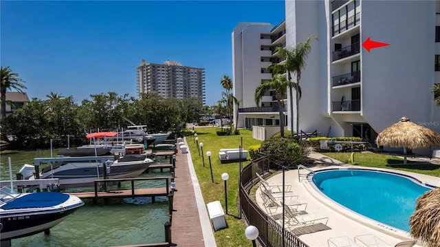 1581 Gulf Blvd Unit 301N, Clearwater Beach, FL 33767 - community pool with a water view, a lawn, a boat dock, and boat lift