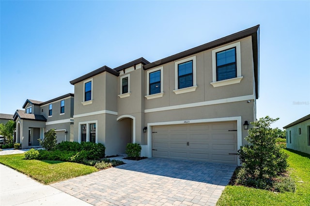 14623 Horse Trot Rd, Lithia, FL 33547 - view of property with stucco siding, decorative driveway, and a garage