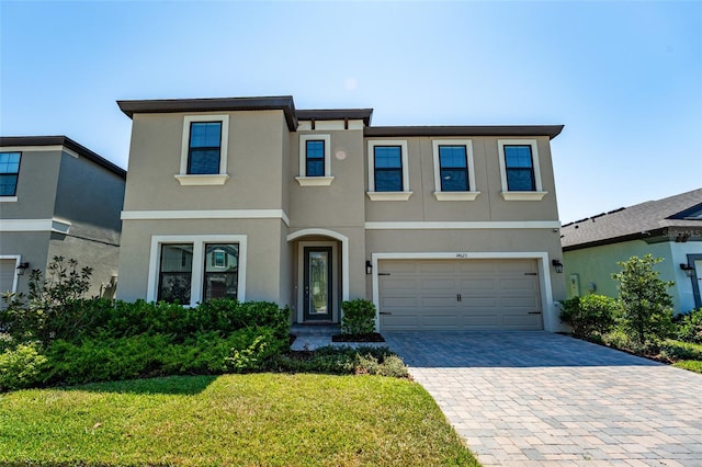 14623 Horse Trot Rd, Lithia, FL 33547 - view of front facade with stucco siding, decorative driveway, an attached garage, and a front yard