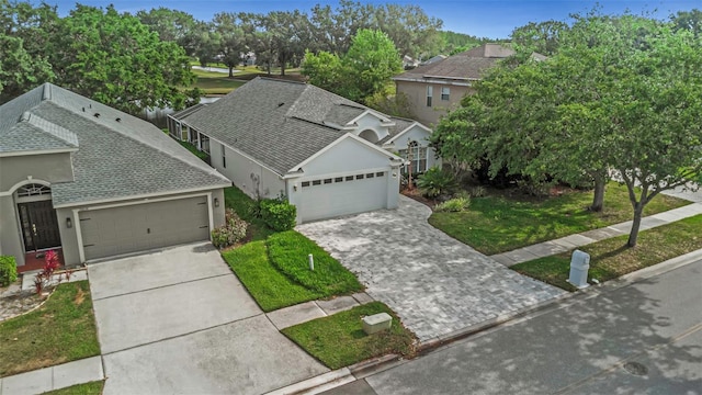 view of front facade featuring a garage, stucco siding, driveway, and a shingled roof