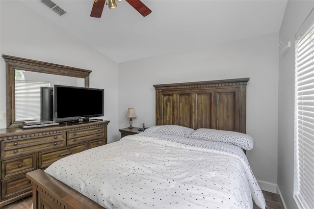 bedroom featuring ceiling fan, visible vents, baseboards, and vaulted ceiling