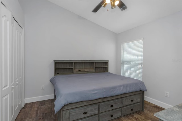 bedroom with baseboards, dark wood-style floors, and vaulted ceiling