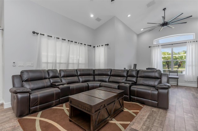 living room with high vaulted ceiling, a ceiling fan, baseboards, recessed lighting, and wood finished floors