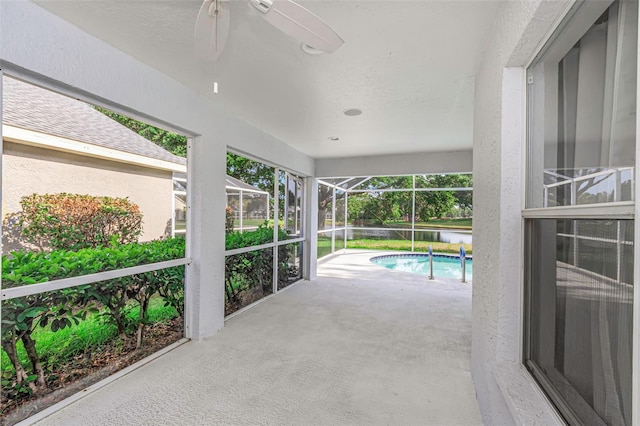 exterior space with glass enclosure and an outdoor pool
