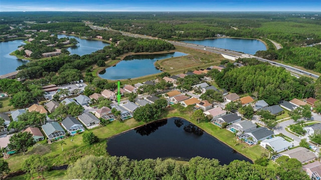 birds eye view of property featuring a water view, a view of trees, and a residential view