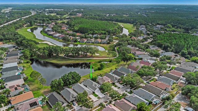 birds eye view of property with a residential view, view of golf course, a water view, and a forest view