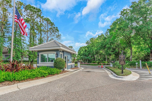 view of street with curbs and a gated entry