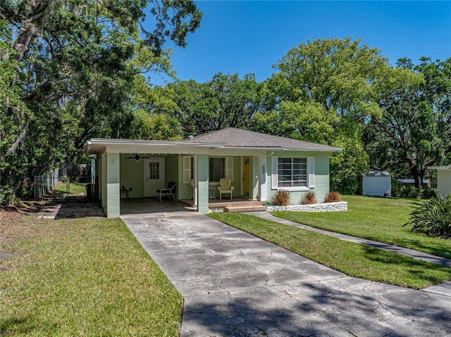 131 Oak Park Ave, Brooksville, FL 34601 - view of front of property with concrete driveway, concrete block siding, a carport, a porch, and a front yard