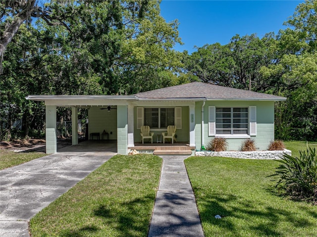 131 Oak Park Ave, Brooksville, FL 34601 - view of front of home featuring concrete driveway, a front lawn, concrete block siding, and covered porch