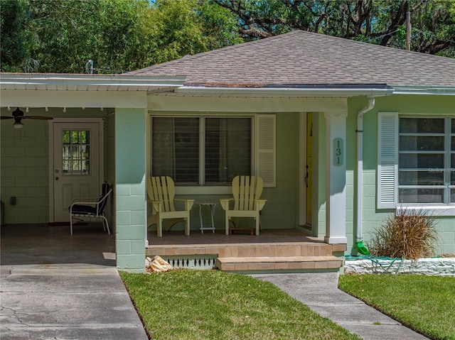 131 Oak Park Ave, Brooksville, FL 34601 - view of front of home featuring roof with shingles, concrete block siding, a ceiling fan, and covered porch