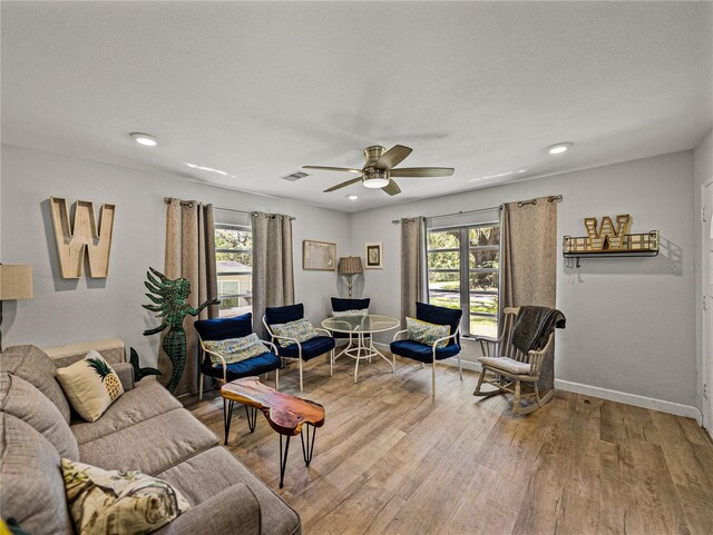 131 Oak Park Ave, Brooksville, FL 34601 - living room featuring ceiling fan, a healthy amount of sunlight, wood finished floors, and visible vents