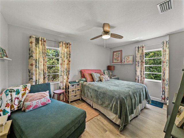 131 Oak Park Ave, Brooksville, FL 34601 - bedroom featuring light wood-type flooring, visible vents, ceiling fan, and multiple windows