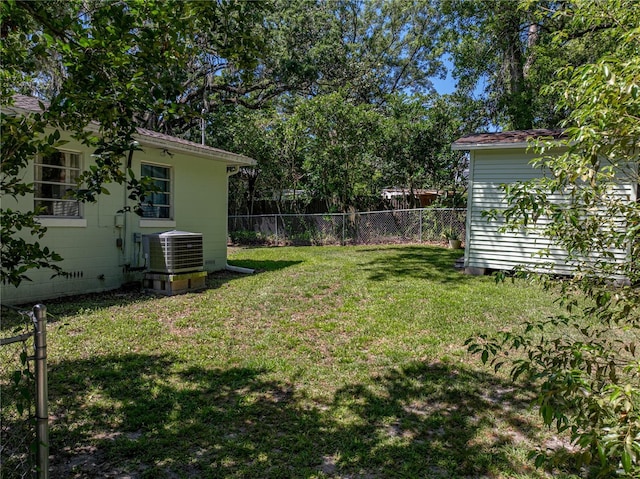 131 Oak Park Ave, Brooksville, FL 34601 - view of yard with fence, an outdoor structure, and central AC unit