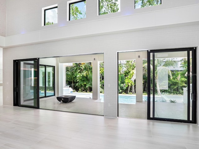 doorway to outside with a high ceiling