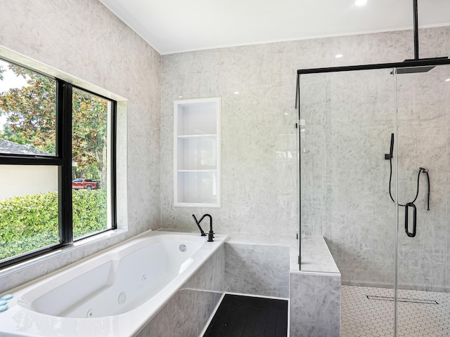 bathroom featuring a whirlpool tub, a shower stall, and tile patterned flooring