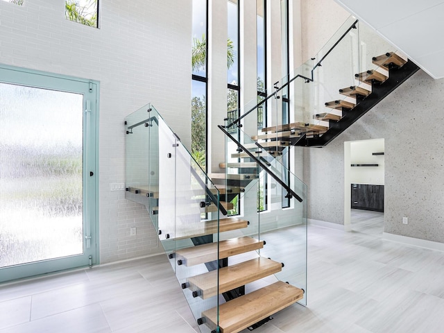 stairway with tile patterned floors and plenty of natural light