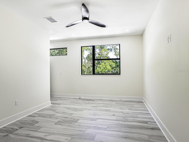 spare room with recessed lighting, visible vents, a ceiling fan, and baseboards