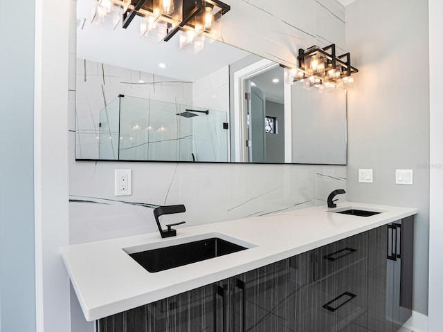 full bath featuring backsplash, a sink, double vanity, and a stall shower