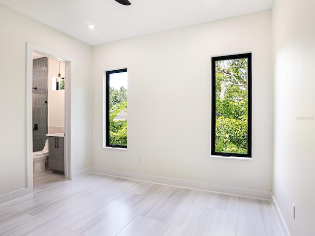 unfurnished bedroom featuring connected bathroom, baseboards, a ceiling fan, and recessed lighting