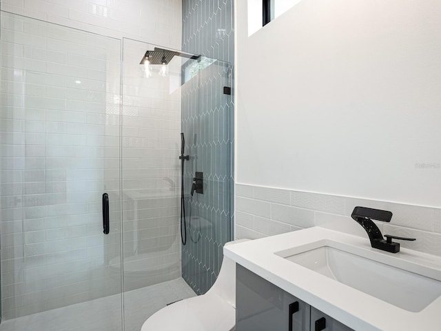 full bathroom featuring a shower stall, a sink, wainscoting, tile walls, and toilet