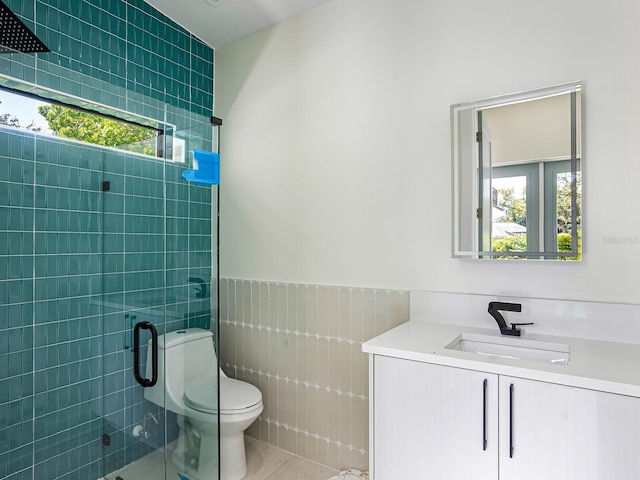bathroom featuring tile walls, vanity, a stall shower, and plenty of natural light