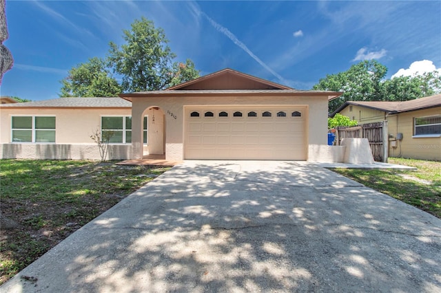 11210 Wheeling Dr, Tampa, FL 33625 - single story home with concrete driveway, stucco siding, and a garage