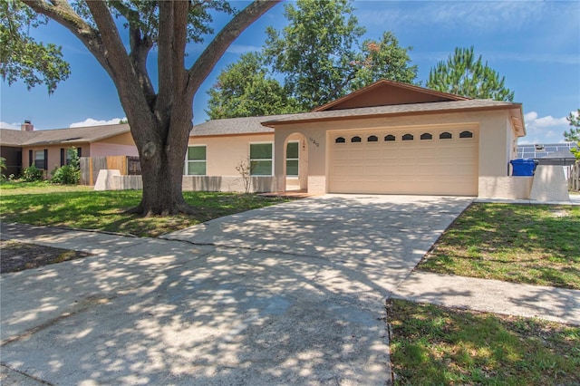 11210 Wheeling Dr, Tampa, FL 33625 - ranch-style house featuring stucco siding, concrete driveway, and an attached garage